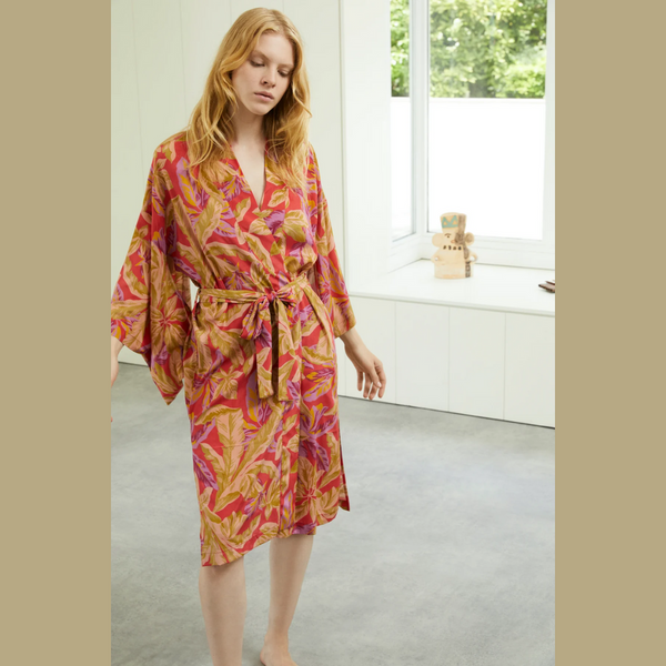 Vibrant tropical print kimono with a tie waist, long-sleeve, and knee-length drop.
